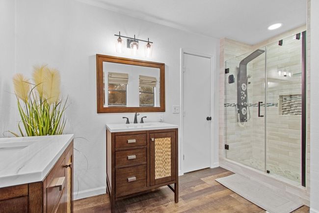 Bathroom with walk in shower, hardwood / wood-style floors, and vanity | Image 26