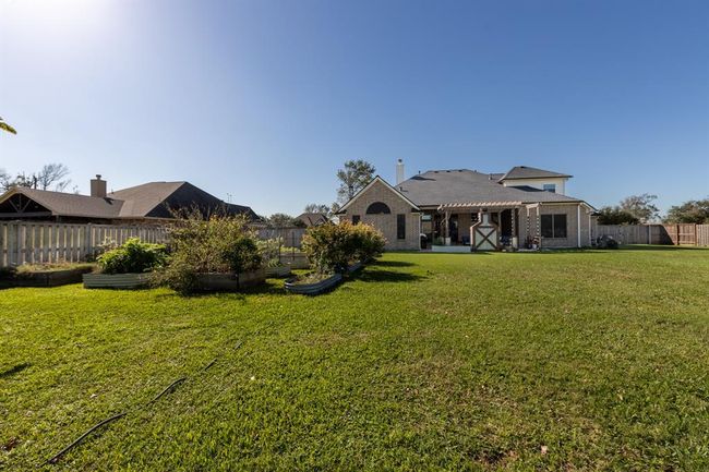 Seller has added several raised garden beds, recently fully fenced backyard w/16' double metal framed gate, this is the perfect area to add your shop | Image 38