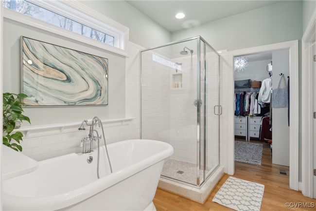 Bathroom with a soaking tub, a spacious closet, wood finished floors, and a shower stall | Image 22