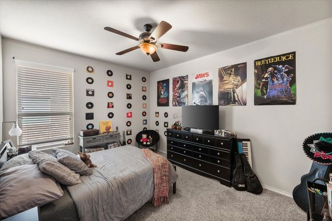 Carpeted bedroom with ceiling fan | Image 28
