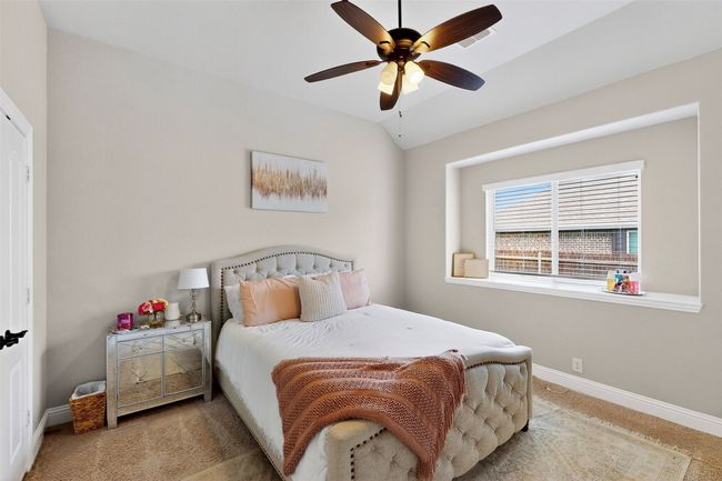 Bedroom with carpet flooring, baseboards, and a ceiling fan | Image 28