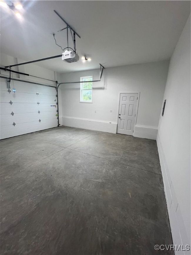 Garage with baseboards and a garage door opener | Image 26