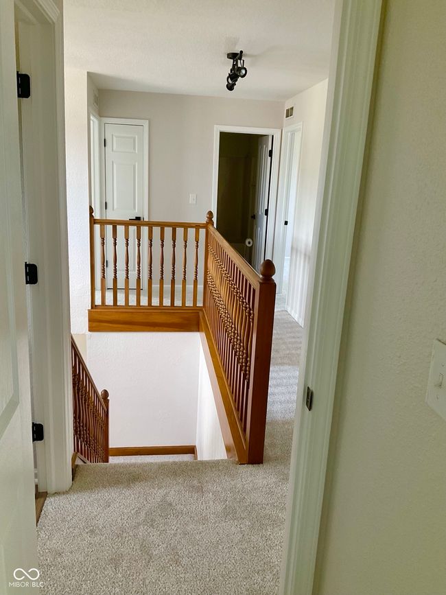 Bright and open upper hallway with new carpet and paint. | Image 34