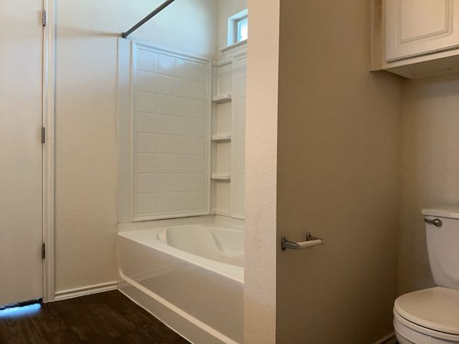 Bathroom featuring dark wood-type flooring and shower combination | Image 21