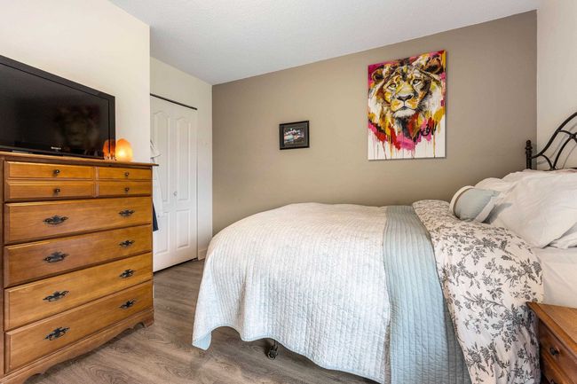 Bedroom with wood finished floors and a closet | Image 15