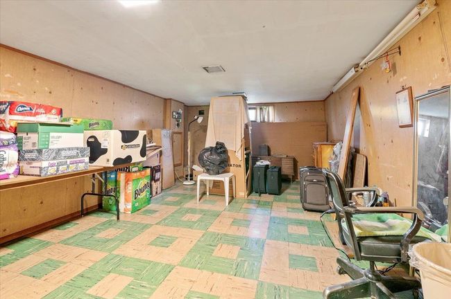 Below grade area with light flooring and wood walls | Image 22