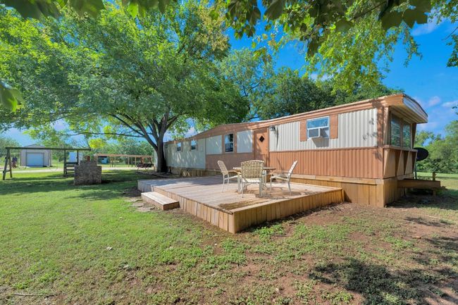 Back of house with a deck and a yard | Image 35