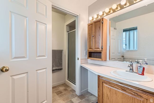 Full bathroom featuring a shower stall and vanity | Image 13