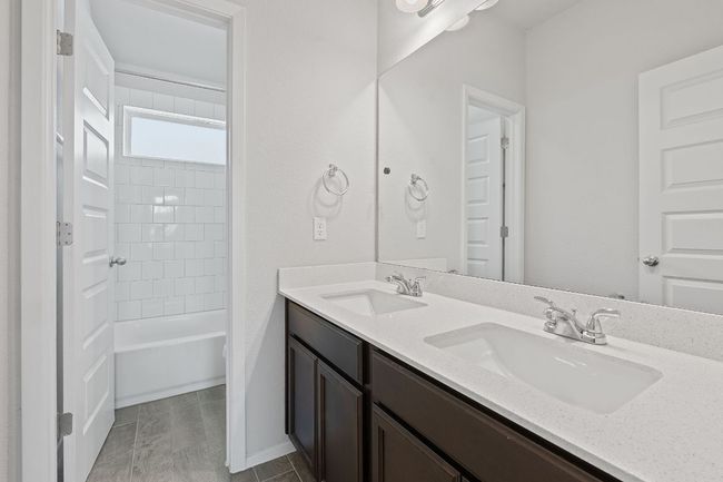 Bathroom with double vanity and tub / shower combination | Image 27