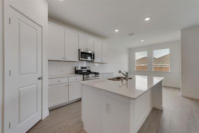 Kitchen featuring sink, appliances with stainless steel finishes, and white cabinets | Image 3