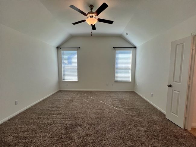 Bonus room featuring dark colored carpet, lofted ceiling, and a ceiling fan | Image 29