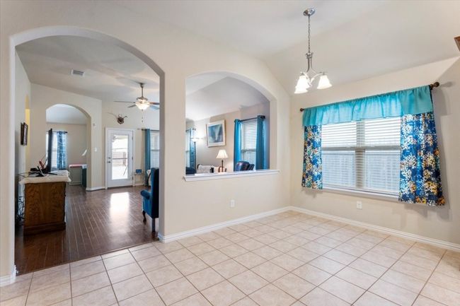 Dining area has wide entry to living room & big window for great lighting. | Image 12