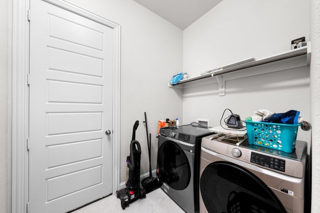 Laundry area with independent washer and dryer and light tile patterned floors | Image 21