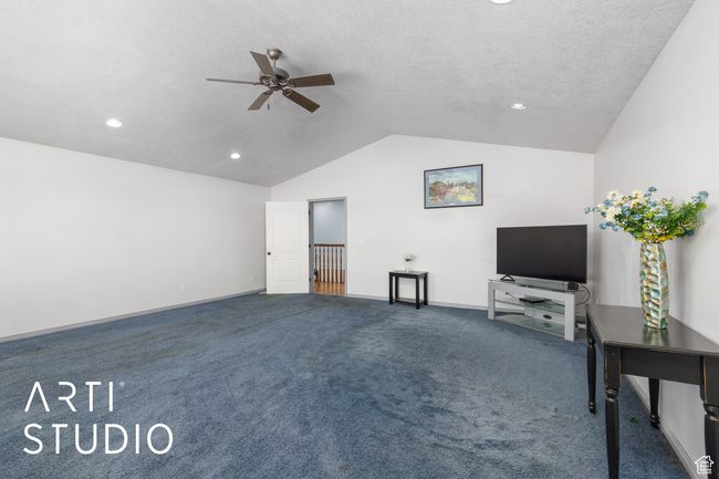 Unfurnished living room featuring a ceiling fan, vaulted ceiling, carpet, recessed lighting, and baseboards | Image 28