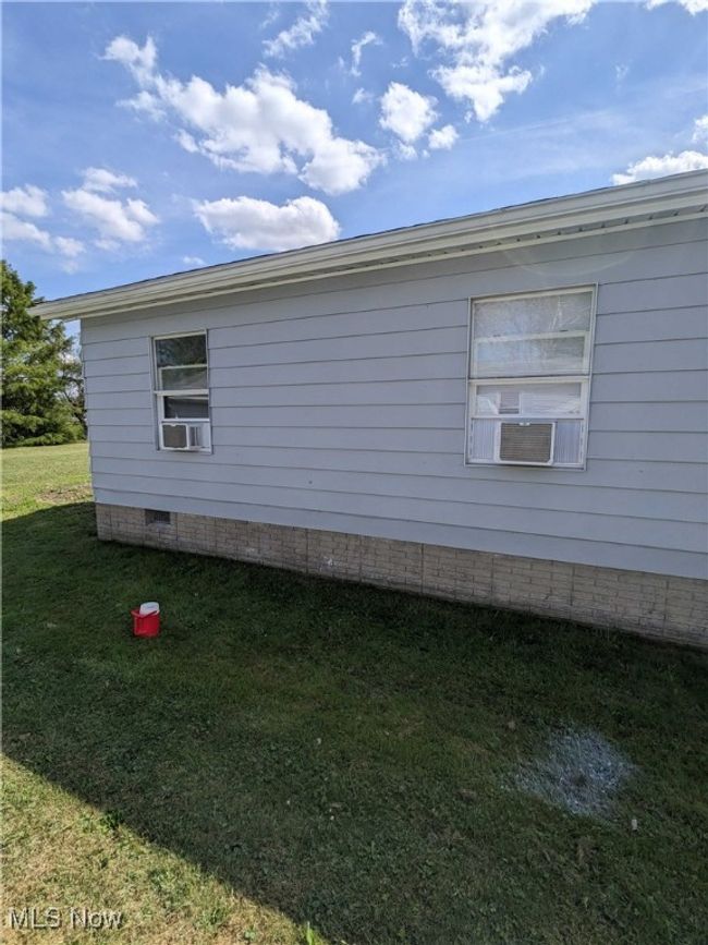 View of side of property with cooling unit and a lawn | Image 12