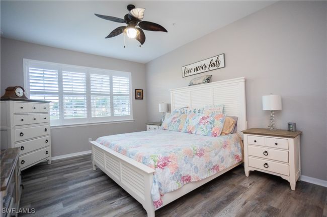Bedroom with dark wood-style floors, ceiling fan, and baseboards | Image 5