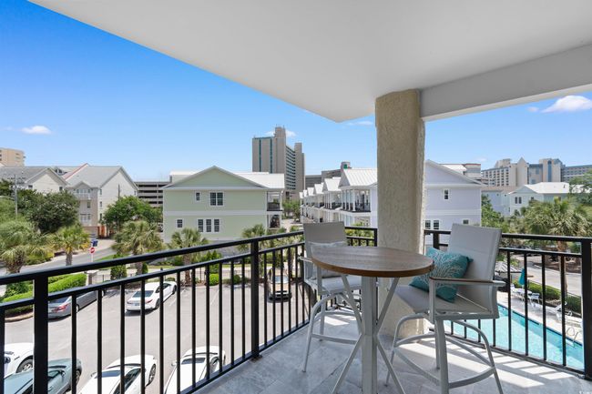 Balcony with a residential view and view of pool area | Image 23