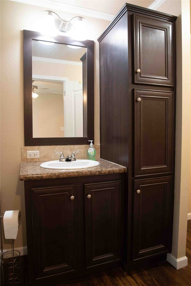 Master Bathroom featuring vanity, baseboards, ornamental molding, and wood finished floors | Image 31