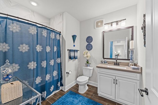 Thoughtfully positioned full bath with quality finishes, offering convenience for guests or roommates and flexibility for future use. | Image 16
