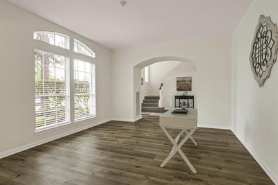 This formal living area is bathed in natural light from large, arched windows that beautifully fram the room. Can be also used as an office space. | Image 3