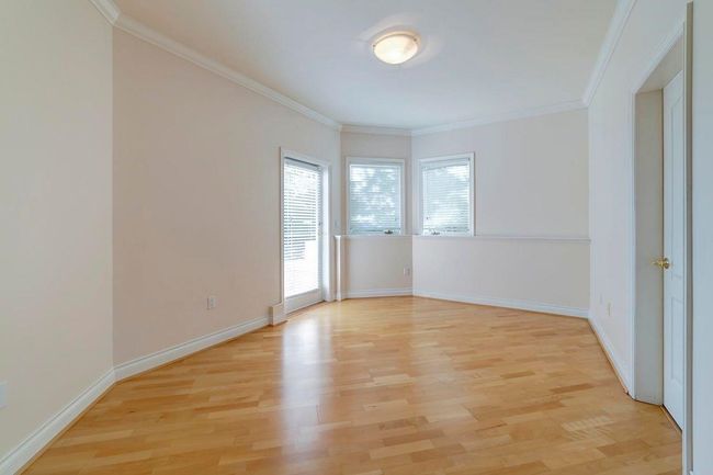 Unfurnished room with light wood finished floors, baseboards, and ornamental molding | Image 10