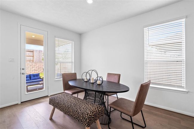 Make memories gathered around the table with your family and friends! This dining room features high ceilings, large window with privacy blinds, and easy access to your kitchen and family room. | Image 13