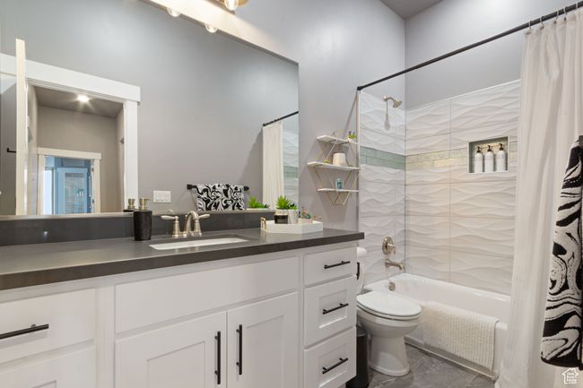 Bathroom with shower / bath combo, marble finish floor, toilet, and vanity | Image 19