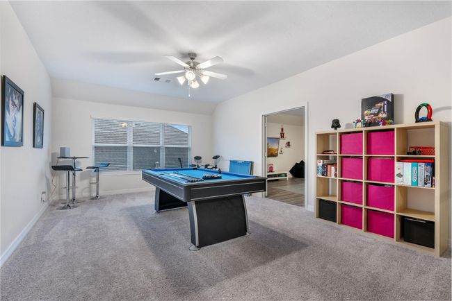 This spacious game room features a pool table size room with ample shelving for storage | Image 28