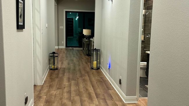 Hallway featuring wood finished floors and a textured wall | Image 10