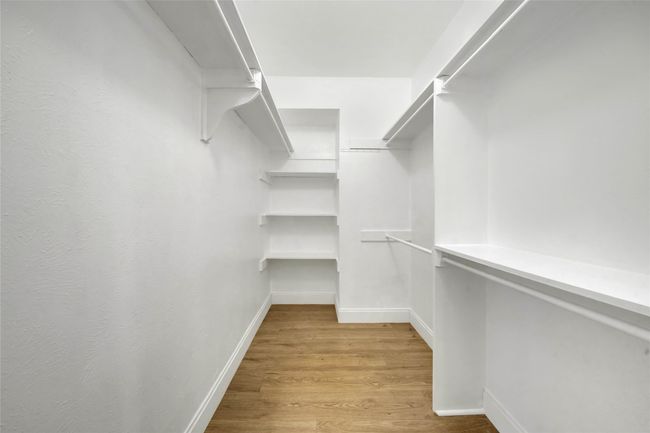 Walk in closet with light wood finished floors | Image 17
