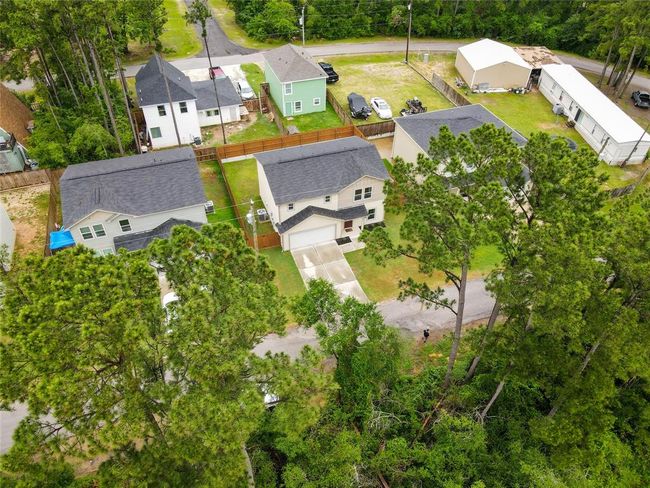 Aerial view with green space. Fully privacy fenced backyard. Double concrete driveway. | Image 36