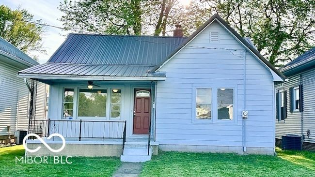 with central air condition unit, covered porch, metal roof, and a front yard | Image 18