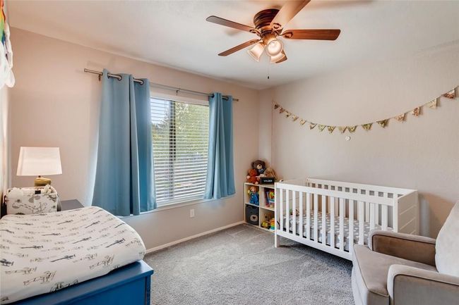 Bedroom featuring carpet flooring, baseboards, and a ceiling fan | Image 16