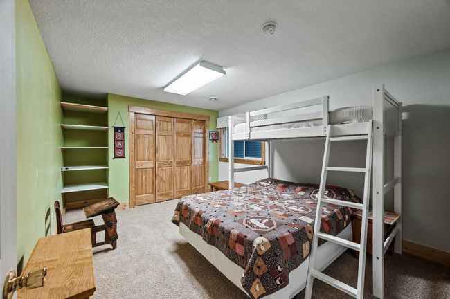 The lower level bedroom is perfect for older children or ensuring guests enjoy a restful stay. | Image 25
