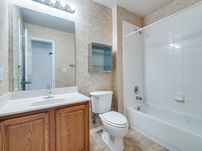 Full bath with vanity, tile patterned flooring, and shower / washtub combination | Image 11
