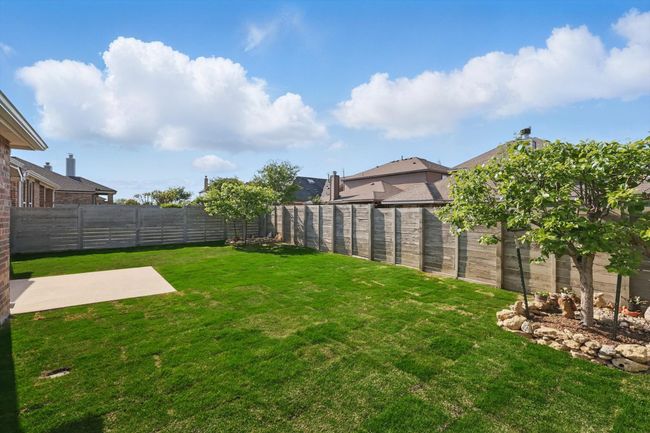 View of yard featuring a fenced backyard and a patio | Image 36