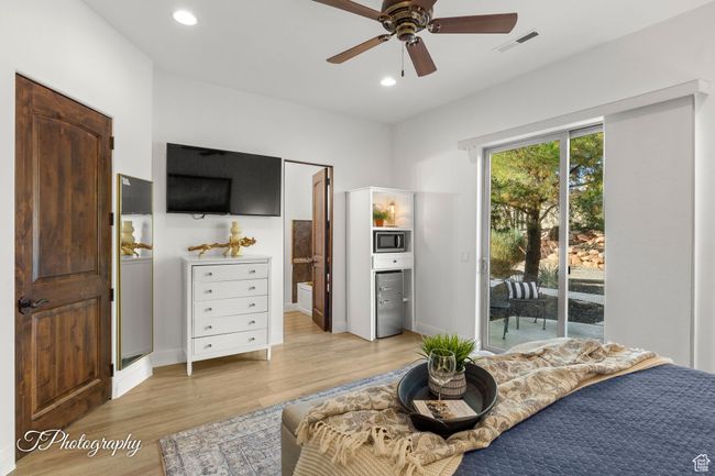 Bedroom with access to exterior, light wood-type flooring, recessed lighting, connected bathroom, and baseboards | Image 33