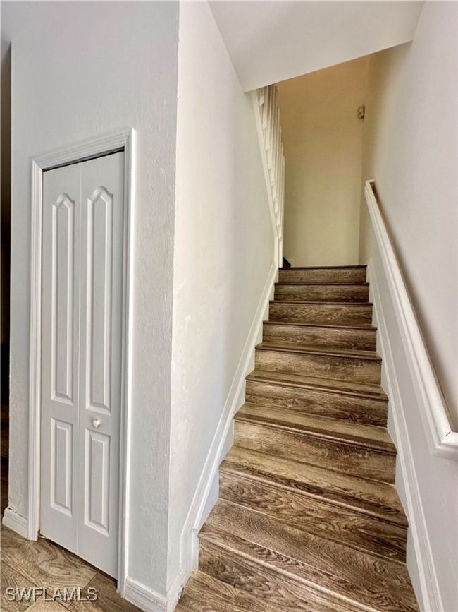 Stairs featuring hardwood / wood-style floors | Image 13