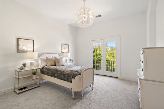 Upstairs Bedroom featuring a chandelier & access to outside. | Image 30