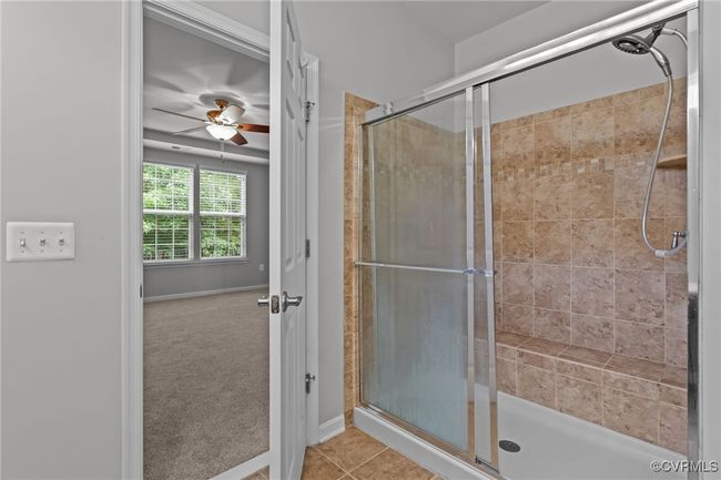 Full bath featuring a stall shower, tile patterned floors, and a ceiling fan | Image 20