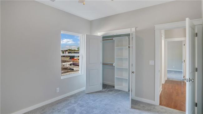 Unfurnished bedroom with carpet, baseboards, and a closet | Image 12