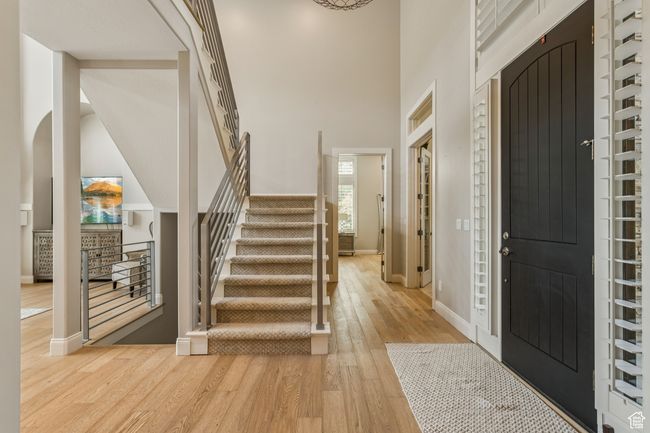 Foyer featuring light wood-style floors, stairs, and a high ceiling | Image 9