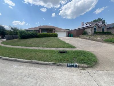 Single story home with a garage and a front lawn | Image 1