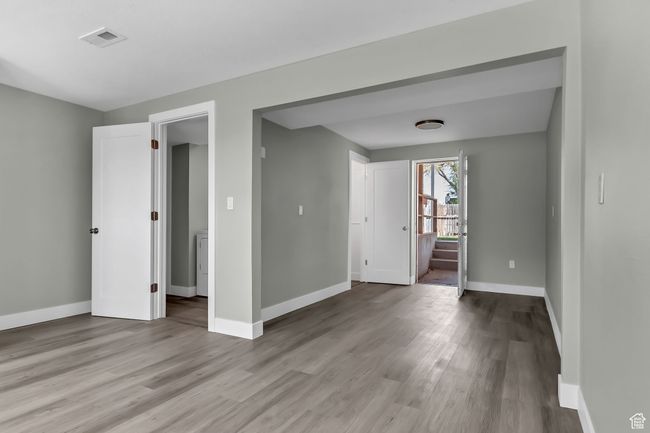 Unfurnished room with baseboards, visible vents, and wood finished floors | Image 22