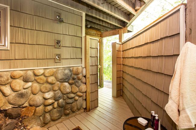 Just around the corner from the walkout lower level, you have an amazing outdoor shower! | Image 12
