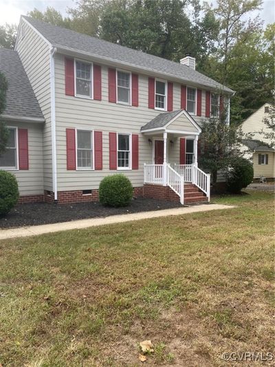 Colonial-style house with a front yard | Image 1