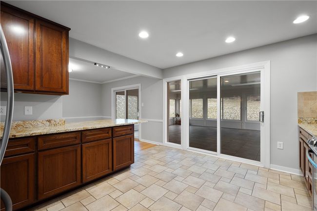 Sliding door to the expansive sun room. | Image 12