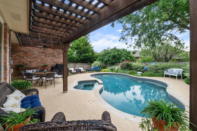 View of pool featuring a pergola, fenced backyard, outdoor dining area, and a pool / hot tub. | Image 29