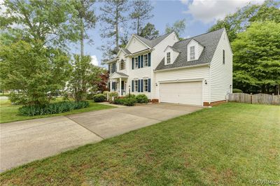 View of front of home with a garage and a front lawn | Image 2