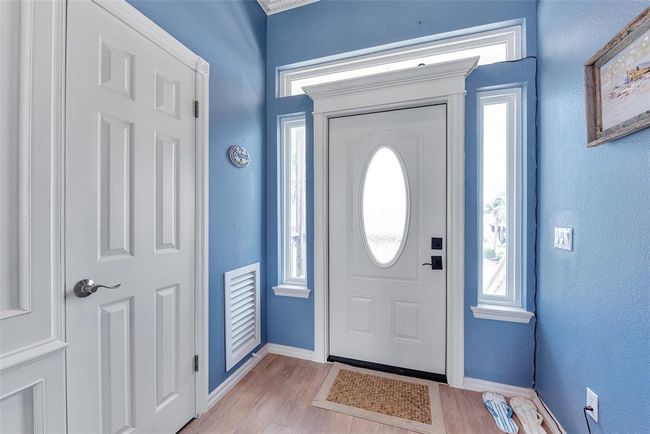 Step inside to a bright and welcoming entry and a convenient coat closet for added storage. | Image 4